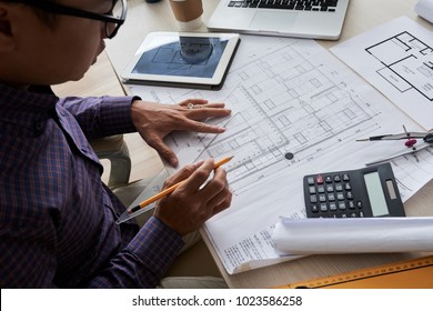 Architect Drawing Blueprint Of The Building