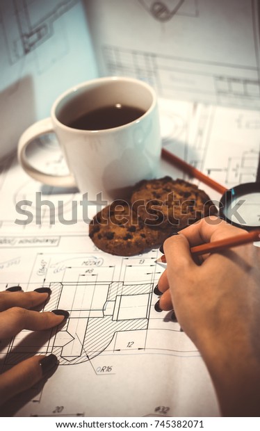 Architect drawing blueprints, architectural
project in progress