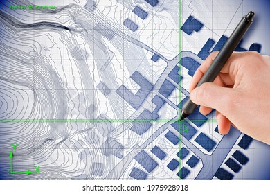 Architect drawing with a digital pen over an imaginary cadastral map of territory with buildings and roads drawn with a CAD (Computer-Aided-Design) computer software in dwg format file. - Shutterstock ID 1975928918
