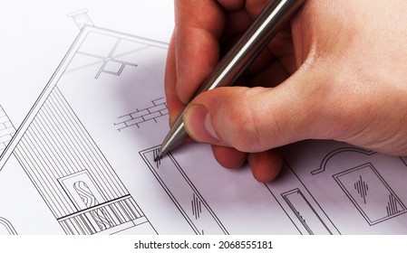 Architect drawing a home design - Shutterstock ID 2068555181