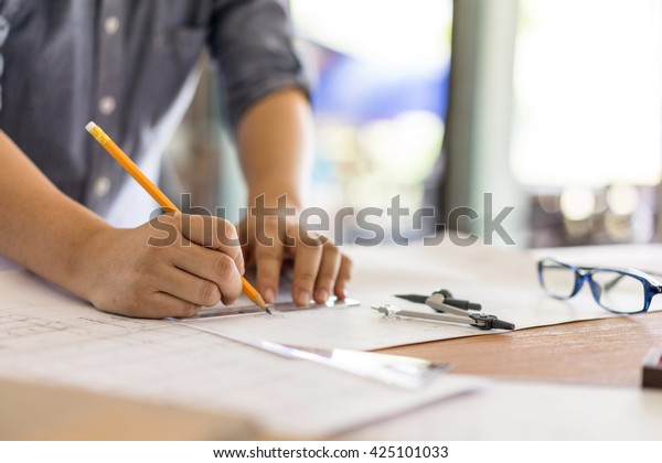 architect drawing on blueprint architectural
concept, soft focus