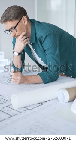Architect drawing precise lines and curves on blueprint with a compass, focusing on drafting detailed plans for new construction. Architecture and business concept