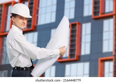 An architect with drawings in his hands. Man supervises construction work. Foreman and construction. - Shutterstock ID 2164448779