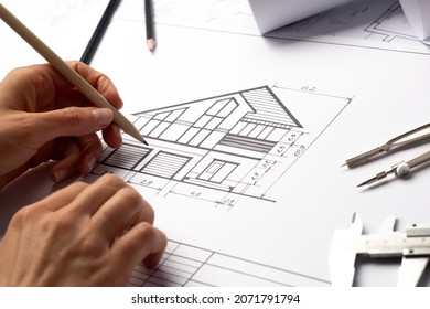 An architect draws a house project. Blueprints. Designer desktop. Engineering construction sketches. - Powered by Shutterstock