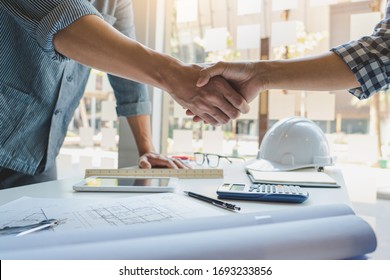 Architect And Engineer Construction Workers Shaking Hands While Working For Teamwork And Cooperation Concept After Finish An Agreement In The Office Construction Site, Success Collaboration Concept