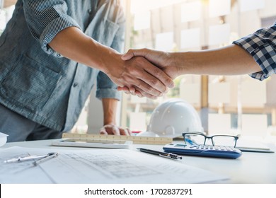 Architect And Engineer Construction Workers Shaking Hands While Working For Teamwork And Cooperation Concept After Finish An Agreement In The Office Construction Site, Success Collaboration Concept