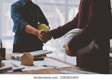 Architect and engineer construction workers shaking hands after successful collaboration. working site, Construction, contract between two companies structure concept
