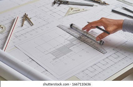 Architect engineer contractor design working drawing sketch plan blueprint and making architectural construction house building in architect studio.                              - Powered by Shutterstock