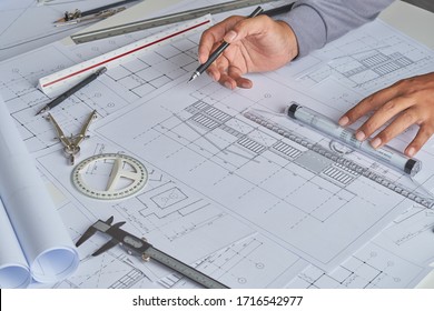 Architect engineer contractor design working drawing sketch plan blueprint and making architectural construction house building in architect studio.                             