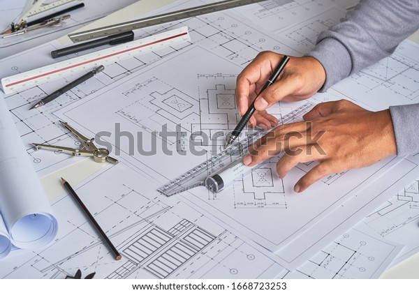 Architect engineer\
contractor design working drawing sketch plan blueprint and making\
architectural construction house building in architect studio.     \
                      \
