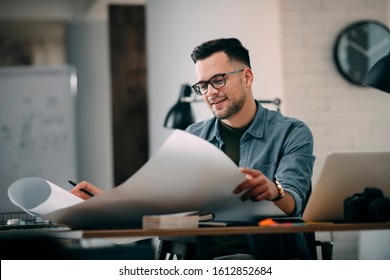
Architect Engineer Design Working Planning Concept.
Portrait of a smiling young businessman working on blueprints at the office. - Shutterstock ID 1612852684