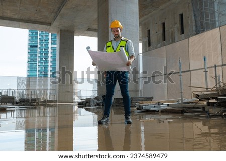 architect engineer designing a structure holding tablet, walkie talkie, drawing