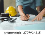 architect, engineer, engineering, architecture, design, plan, plans, construction, Engineers and architects review technical blueprints together, marking details and coordinating design plans.