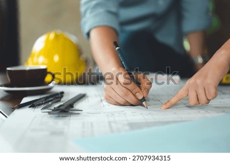 architect, engineer, engineering, architecture, design, plan, plans, construction, Engineers and architects review technical blueprints together, marking details and coordinating design plans.