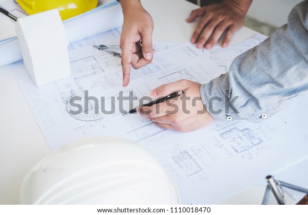 Architect or Engineer meeting working with
partner on blueprint for architectural project in progress,
construction and structure
concept.