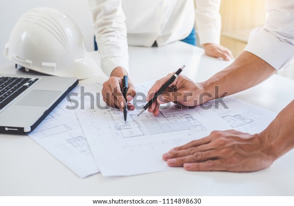 Architect or Engineer meeting working with\
partner on blueprint for architectural project in progress,\
construction and structure\
concept.