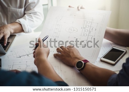 Architect or engineer team working with blueprints building plan design project in office Construction engineering tools and structure concept.