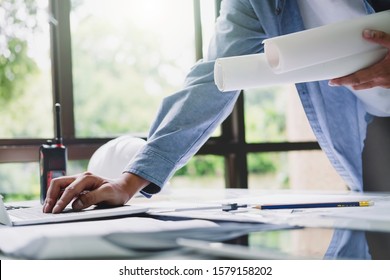Architect or engineer working in office with blueprints,engineer inspection in workplace for architectural plan,sketching a construction project ,selective focus,Business construction concept.