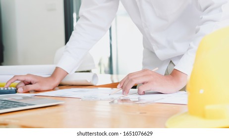 Architect or engineer working in office with blueprints,engineer inspection in workplace for architectural plan,sketching a construction project ,selective focus,Business construction concept.