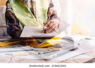 Architect or engineer working in office with blueprints,engineer inspection in workplace for architectural plan,sketching a construction project ,selective focus,Business construction concept.