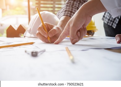 Architect or engineer working in office with blueprints,engineer inspection in workplace for architectural plan,sketching a construction project ,selective focus,Business construction concept.