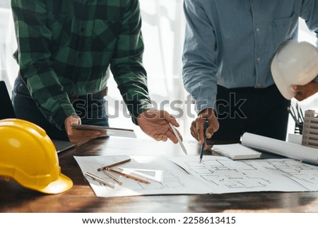 Architect and engineer working in office with blueprints,engineer inspection in workplace for architectural plan,sketching a construction project.