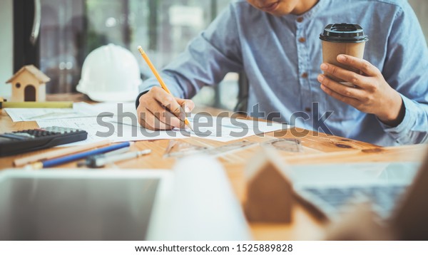 Architect or engineer working in office,\
Construction concept. Engineering\
tools.
