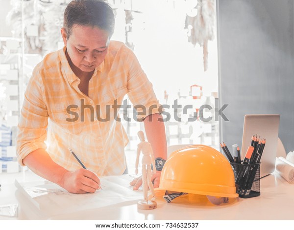 Architect or engineer working in office,\
Construction concept. Engineering tools.Vintage tone retro filter\
effect,soft focus(selective\
focus).