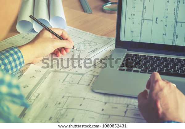 Architect or engineer working in office on\
blueprint. Architects\
workplace