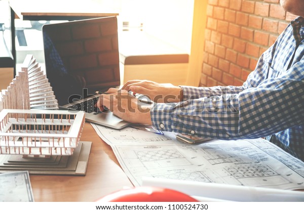 Architect or engineer working in office on\
blueprint. Architects\
workplace