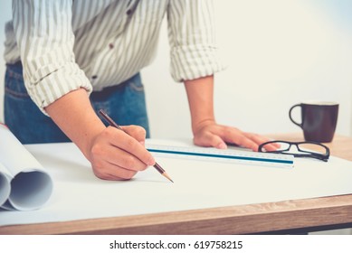 Architect or engineer working on drawing at workplace - architectural project, Construction concept.