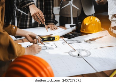 architect or engineer working on table use drawing tool on the paper plan for business architectural project.