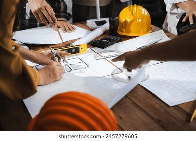 architect or engineer working on table use drawing tool on the paper plan for business architectural project.