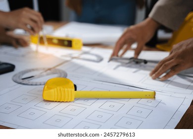 architect or engineer working on table use drawing tool on the paper plan for business architectural project.