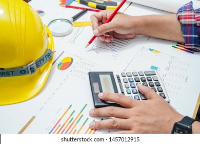 Architect or engineer working project accounting with graph in office, Construction account concept.  
