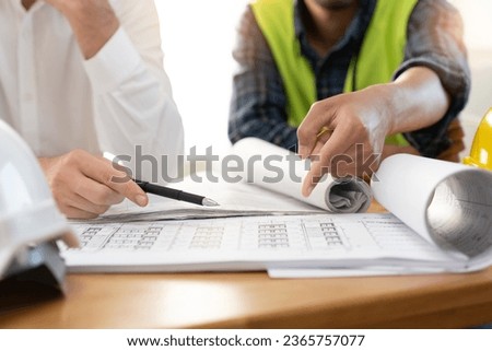 architect explaining client demand plan of construction on the table to contractor.