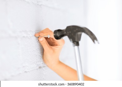 Architect Hammering Nail In Wall