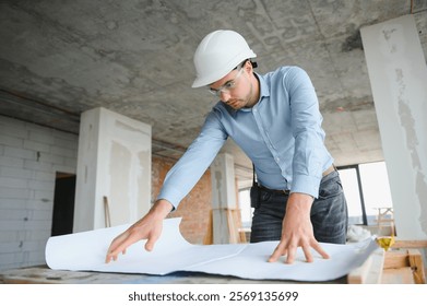 Architect in hard hat with draft.