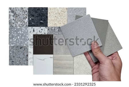architect hold quartz samples compare color with multi texture of square shapes terrazzo artificial stone samples and porcelain ceramic stone tile samples isolated on background with clipping path.