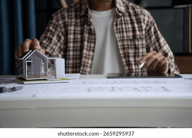 Architect Interior Design drawing checking home blueprint on tablet.