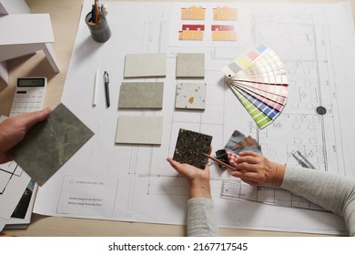 Architect and interior designer discussing floor tile and walls color for project - Shutterstock ID 2167717545