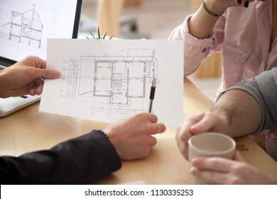 Architect or interior designer showing new apartment plan to couple at meeting, realtor consulting customers making real estate offer, mortgage loan investment and construction concept, close up view - Powered by Shutterstock