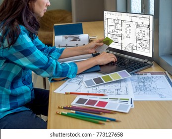 Architect (interior Designer) Working With Drawing,  Material Sample & Laptop Computer In Office / Business Of Real Estate, Home Decoration & Renovation Concept