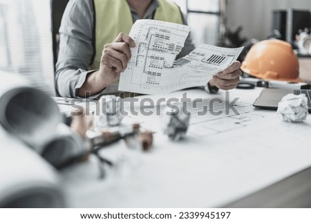 The architect made a mistake in designing the plan and torn paper. Paper crump on blueprint. Fail, mistake and problem concept.