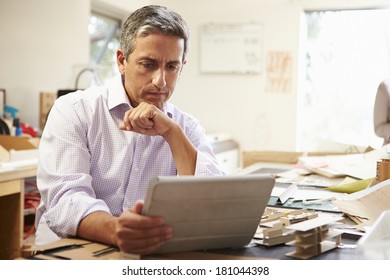 Architect Making Model In Office Using Digital Tablet - Powered by Shutterstock - Get 15% off with code: PIKWIZARD15
