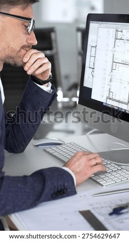 Architect man thinking while working on blueprints and computer, planning new building design in office. Business and architecture concept