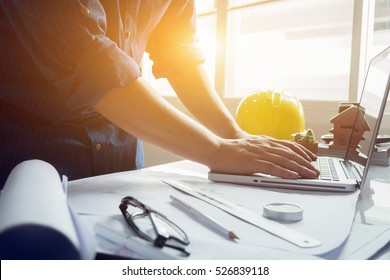 architect man working with laptop and blueprints,engineer inspection in workplace for architectural plan,sketching a construction project ,selective focus,Business concept vintage color - Shutterstock ID 526839118