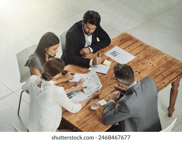 Architect, meeting and business people with blueprint in office for review, discussion or renovation project. Lens flare, architecture firm and employees for conversation, floor plan or teamwork - Powered by Shutterstock