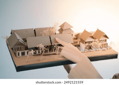 The architect meticulously crafted a miniature model to showcase the precision and craftsmanship of their residential design, a blueprint for a home in an architecture development project. - Powered by Shutterstock
