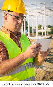 Architect On Building Site Using Digital Tablet